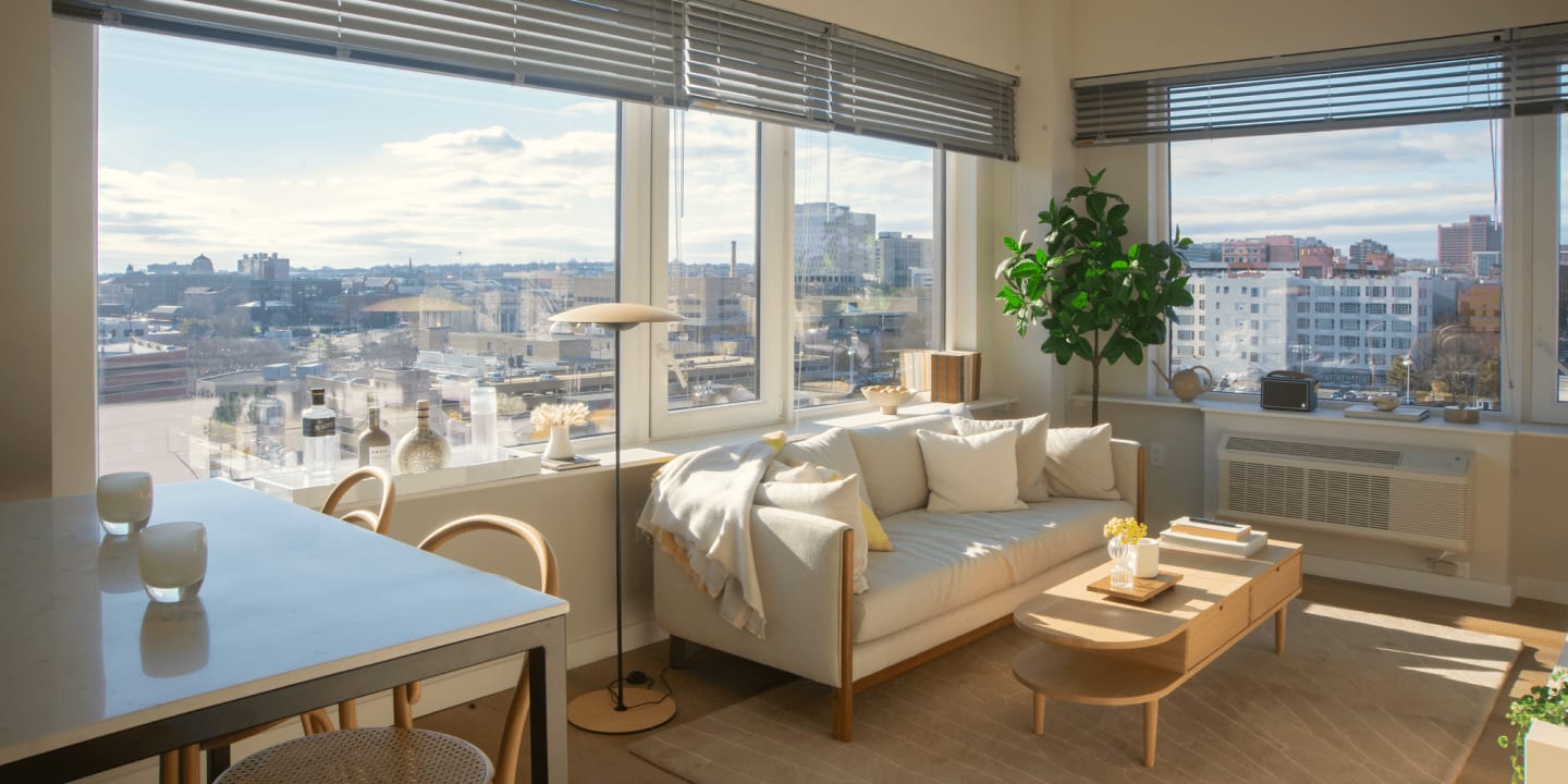 View of the designer living room details including oversized windows at Newark Urby - luxury Newark NJ apartments for rent